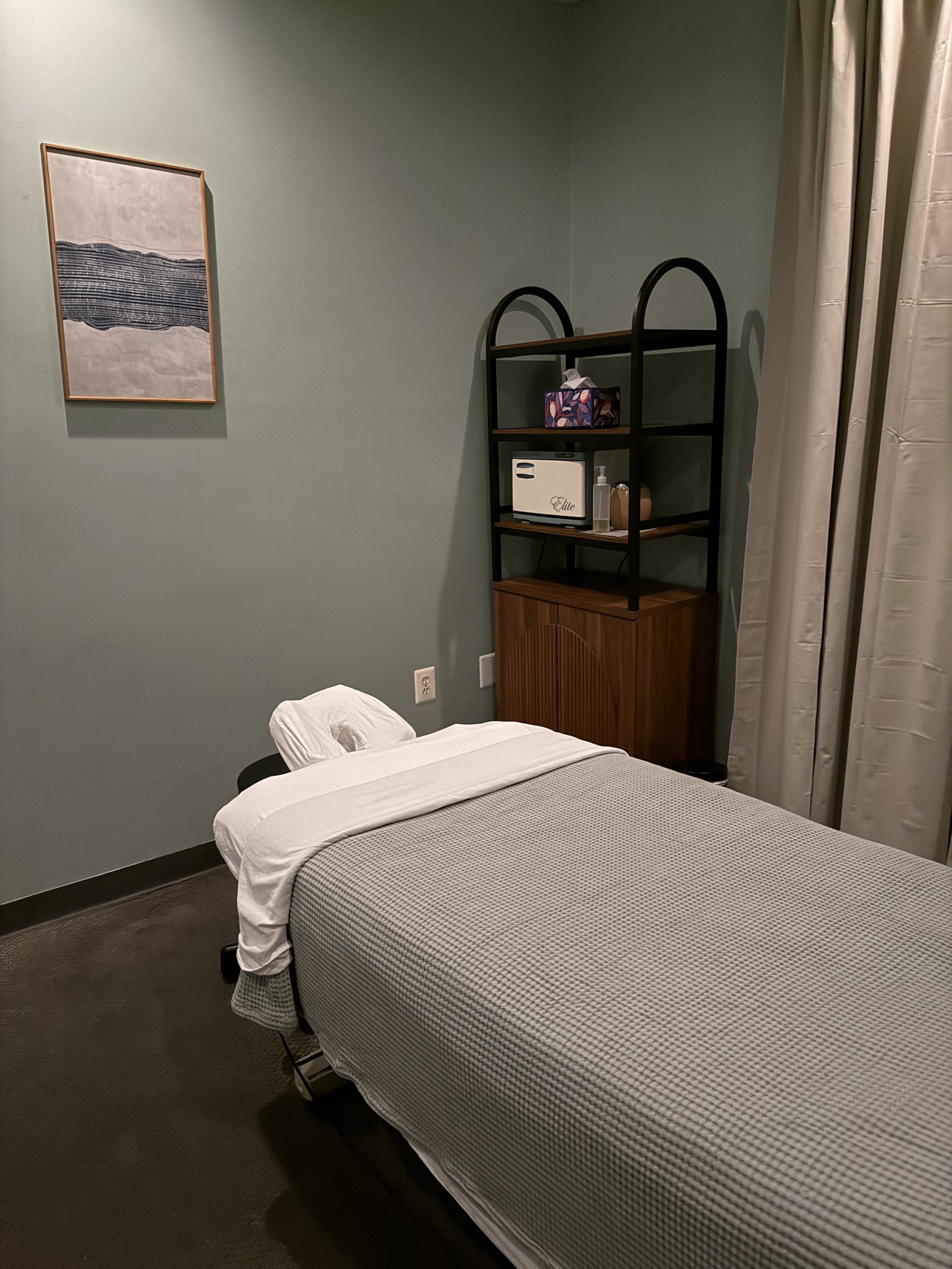 Massage table dressed in fresh linens in a calm treatment room