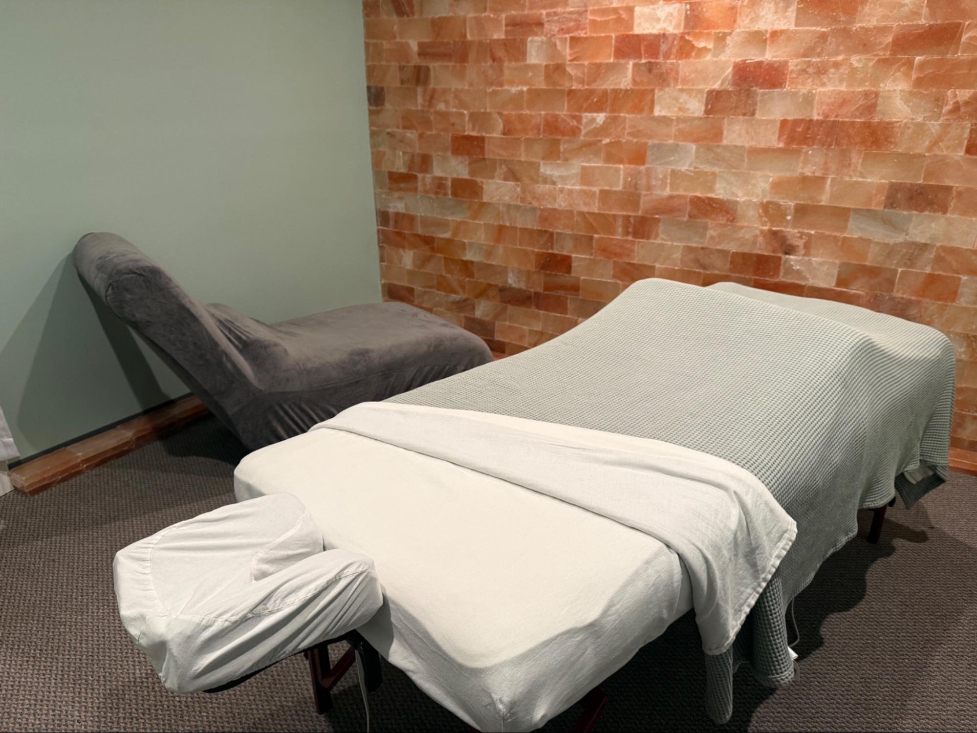 Massage table and lounge chair in the salt room